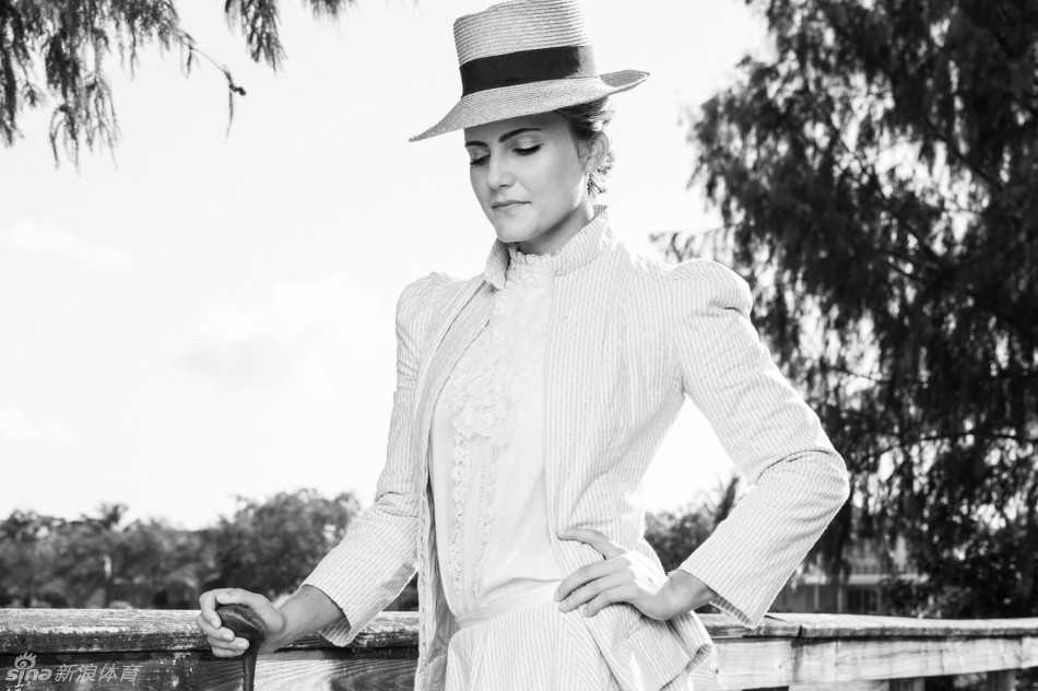 汤普森在复古场景中练习挥杆，厚重的衣裙并未束缚她专注的神情，她双手紧握老式木杆，身体扭转，努力适应着 century-old 的挥杆感觉。