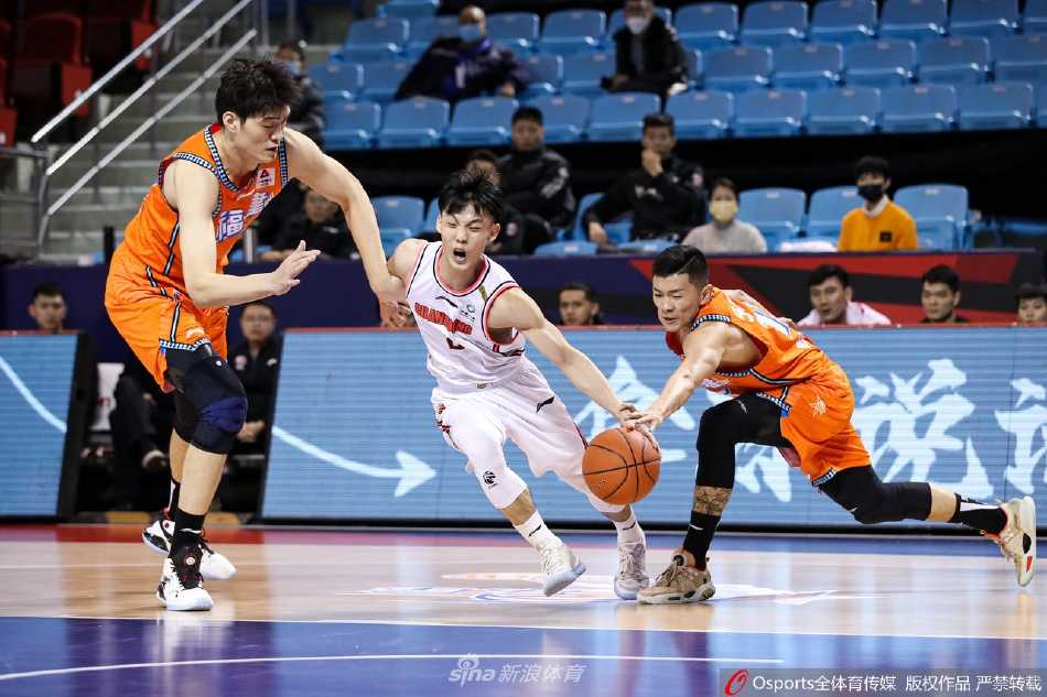 广东队任骏飞在福建队员的围堵中拼抢前场篮板，他肌肉紧绷、全力以赴，展现了卫冕冠军对于每一个球权都锱铢必较的争夺精神。