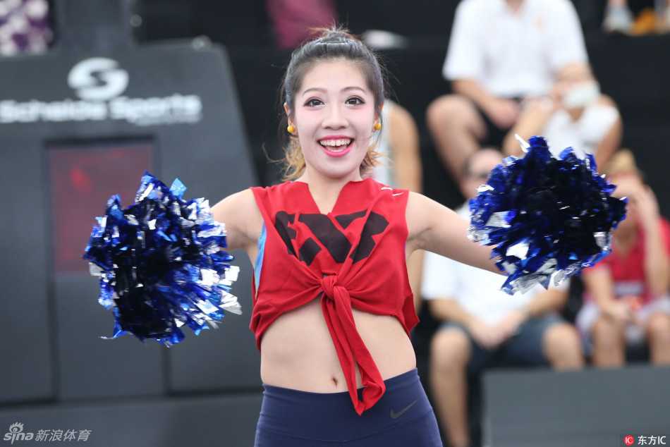 一位篮球宝贝在表演中回眸凝视镜头，动感的动作中带着一丝俏皮，汗水与笑容交织，展现出运动员般的健康与自信。