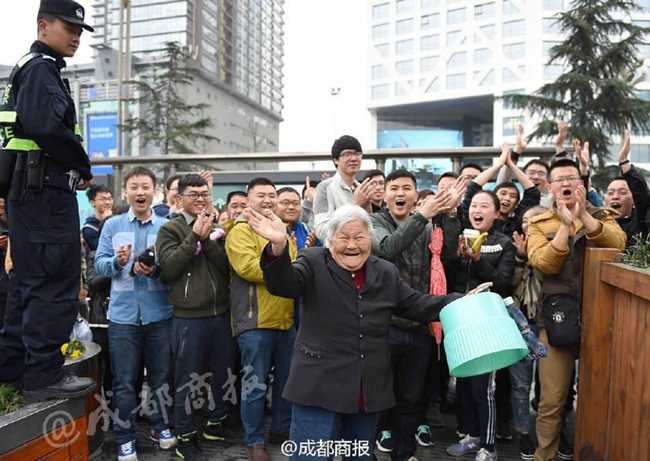 在成功买到球票后，满头银发的孟老太转过身来，面向身后长长的购票队伍。她颤颤巍巍地举起手臂，向那些主动为她让路的数百名热心球迷挥手致意，脸上洋溢着感激与慈祥的笑容，场面温馨而感人。