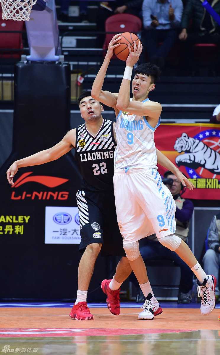 周琦面对防守球员准备起跳投篮，他高举篮球，利用身高臂展优势，试图在对手头顶完成一次轻松的投射。