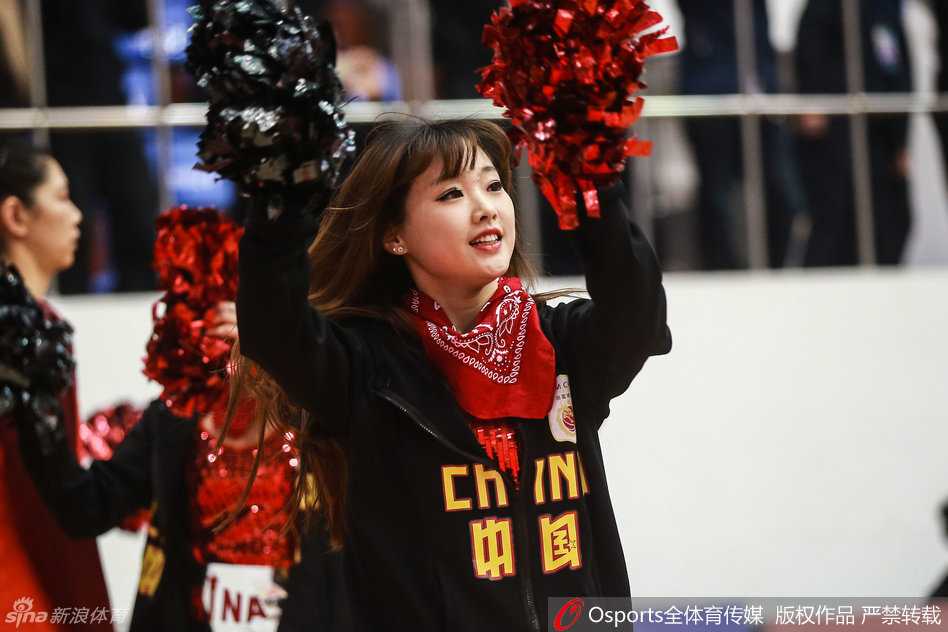 一名啦啦队员俏皮地眨着单眼，嘴角微微上扬，露出可爱的小酒窝，呆萌的表情让人忍不住会心一笑。