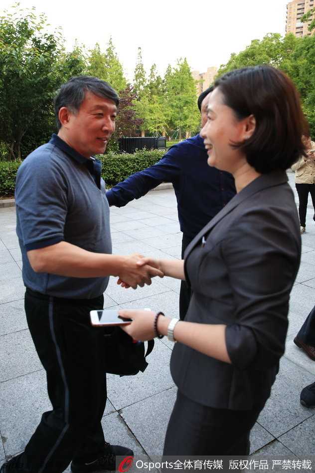 中国男篮领队柴文胜（左）与主教练宫鲁鸣（右）在场边交流，两人神情严肃认真，正讨论着下一阶段的训练重点。