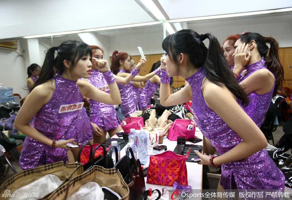 镜头背后的精灵:探秘东莞篮球宝贝的更衣室与赛场芳华 镜头捕捉到了两位宝贝在狭小的更衣室内忘情自拍的瞬间,她们对着手机镜头摆出俏皮的鬼脸,身后的队友则见怪不怪地继续整理着演出服,狭小的空间里洋溢着青春无忧的欢笑声。