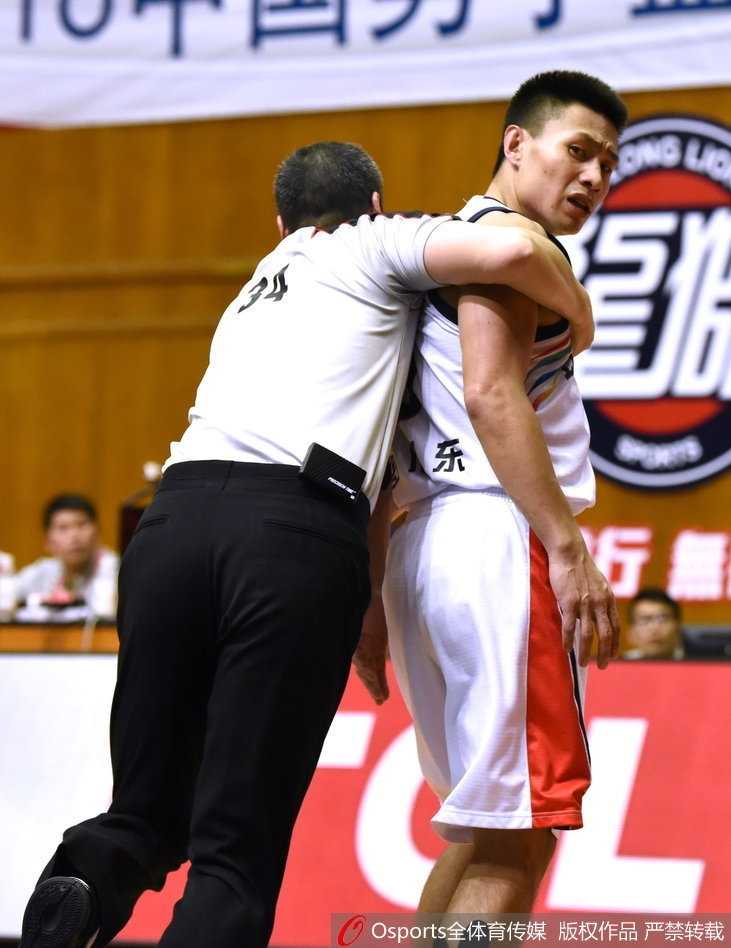 CBA激烈冲突夜:广州大胜天津,赛场火爆瞬间回顾 裁判员奋力挤进人群中央,双臂张开用身体隔开冲突的球员,他眉头紧锁神情严肃,身后是情绪失控的球员被队友死死抱住,现场一片混乱。