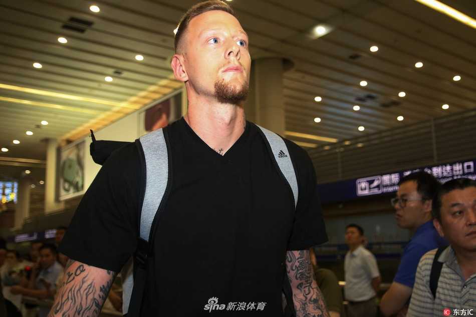 上海大鲨鱼迎新季 重炮明纳拉斯携爱妻空降申城 明纳拉斯与妻子在行李提取处等待,两人侧身相望,眼神交汇间传递着无需言语的默契,背景是繁忙的机场到达大厅