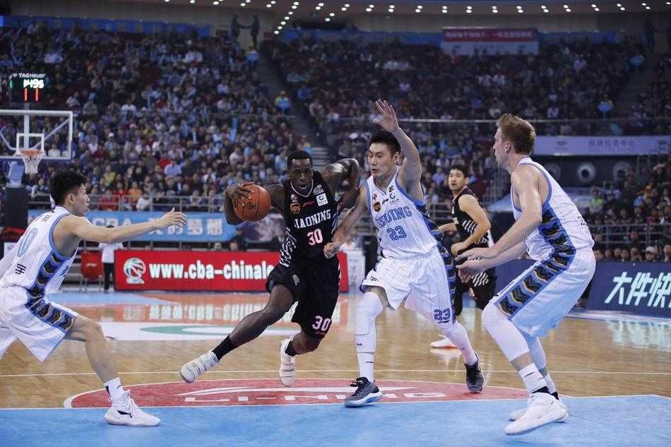 辽宁队球员巴斯与韩德君在篮下奋力卡位，争夺篮板球，肌肉紧绷