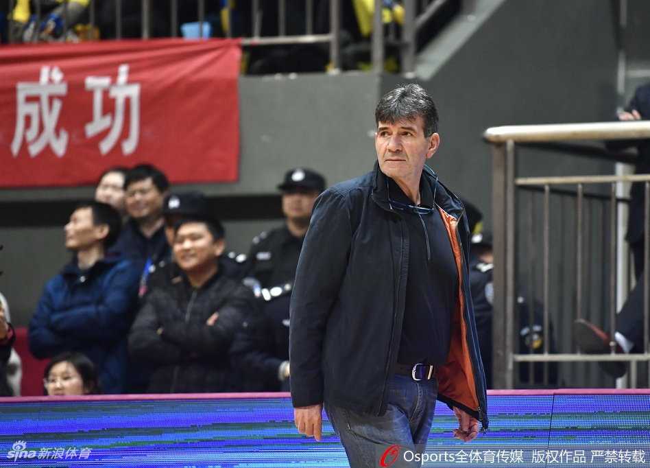 江苏队老将易立突破上篮，身体在空中舒展，面对广东内线巨塔的封盖依然勇敢出手，这是他经验与胆识的体现。