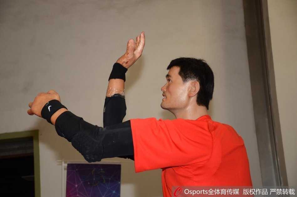 从侧面望去，机器人的面部轮廓和肤色几乎可以乱真，它身上的球衣随着光影泛起褶皱，完美复刻了篮球巨星在场边休憩时的神态。