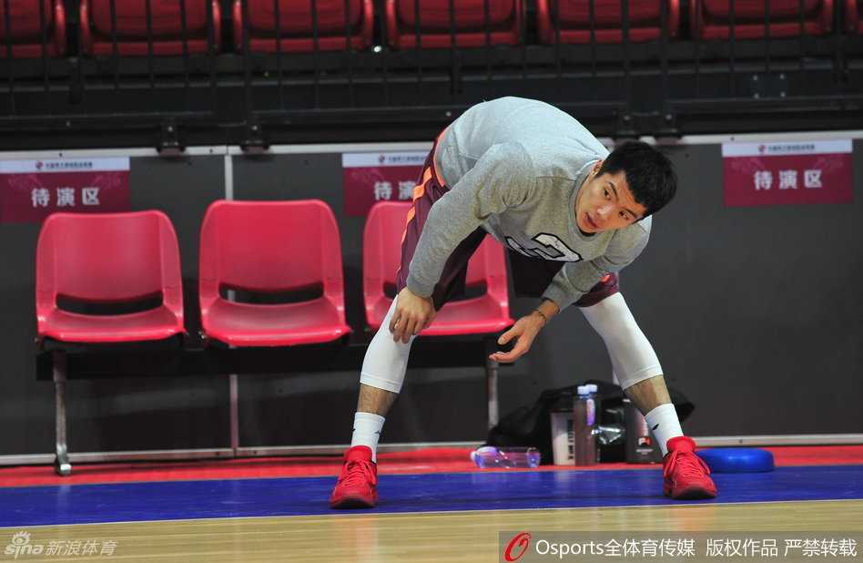 替补后卫王子瑞在球场边线处认真地进行着运球和拉伸热身，随时准备听候教练的召唤。