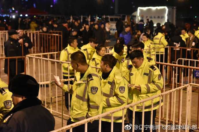 身着整齐制服的公安干警们在本溪体育馆看台就座，他们面带笑容，专注地观看比赛，身后的蓝色助威服球迷与他们形成鲜明对比，气氛热烈而和谐