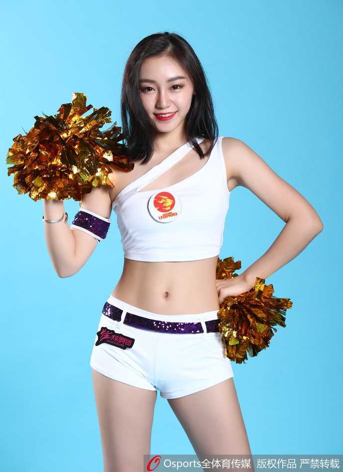 近距离镜头下，一位扎着高马尾的啦啦队员回眸一笑，精致的妆容在灯光下熠熠生辉，眼神中闪烁着自信与活力