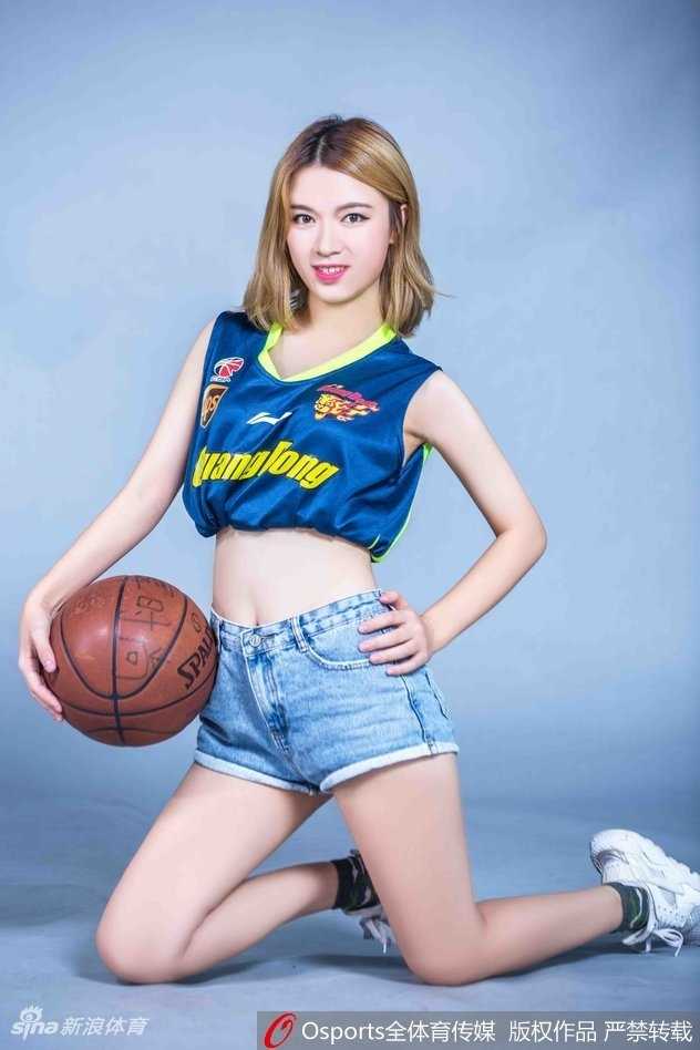 篮球宝贝侧身站立，广东队球衣下的身材曲线玲珑，动感十足