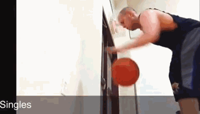 篮球在球员腰间快速环绕，手臂舒展，球从腰后顺畅地交到另一只手中，动作行云流水充满节奏感