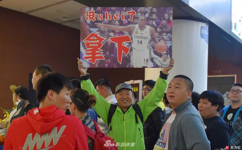 身着一袭黑衣的哈德森面带微笑，亲切地与身旁热情如火的辽篮球迷击掌互动，眼神里满是回家的温暖与喜悦。