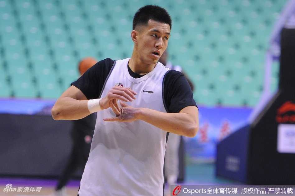 队长杨鸣穿着深色的训练外套，嘴角带着标志性的微笑，一边给身前的小朋友签名，一边轻轻摸了摸孩子的帽子。身后还有几名球迷举着手机记录这一刻，每一张脸上都写满了幸福。