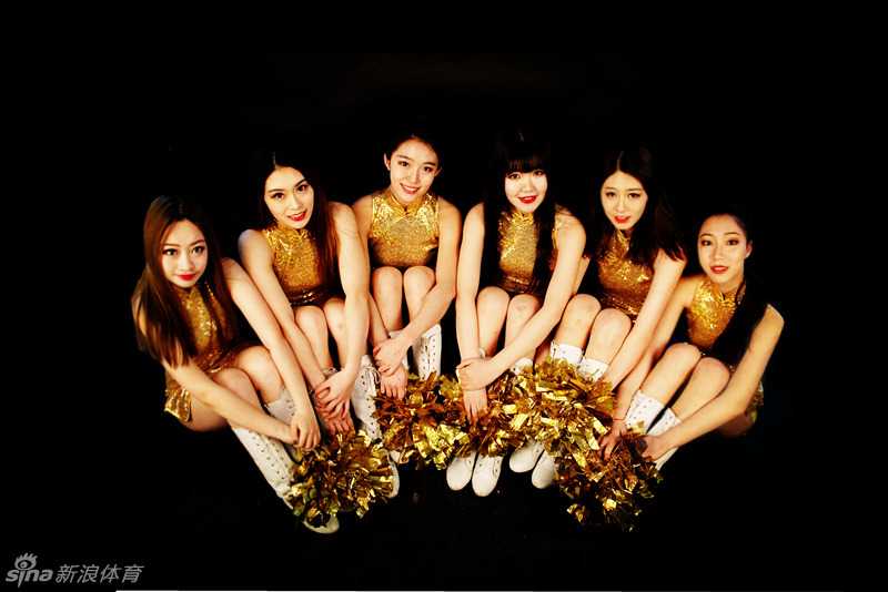 金鸡报晓迎新春 辽篮啦啦队俏皮贺岁 宝贝对着镜头开心地展示自己手中的中国结,身后是仿古的窗棂背景,整体画面充满了节日的喜庆与家庭的温馨感